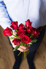 Close up red rose, handsome man Valentine's day romantic suprise flowers.