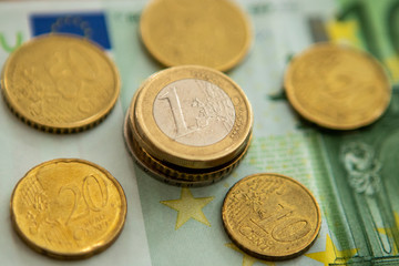 Euro coins on paper bill