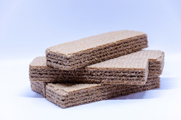 A pile of chocolate wafer biscuits photographed against a white background.