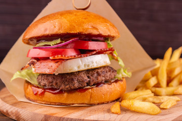 Burger with pepper халапеньо and French fries with ketchup