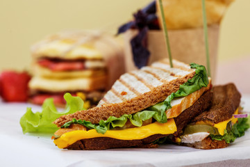 Sandwich with smoked chicken, cheddar cheese, pickled onions, pickled cucumber and sauce.