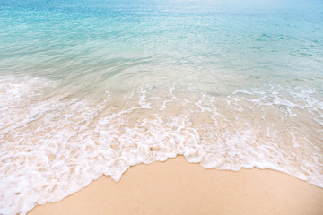 Wave of blue ocean or sea on golden clear sandy beach. Beautiful tropical beach. Background. Vacation and relax concept.