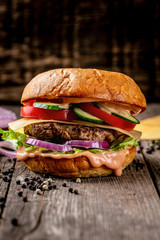 home made tasty hamburger on wooden vintage table. excess weight set. vertical image. menu photo, copy space