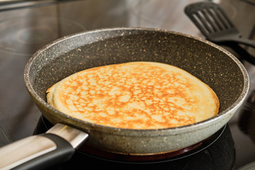 Cooking pancake on frying pan