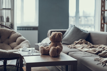 Teddy bear sitting on coffee table in living room