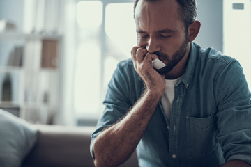 Close up of bearded man sitting with his eyes closed