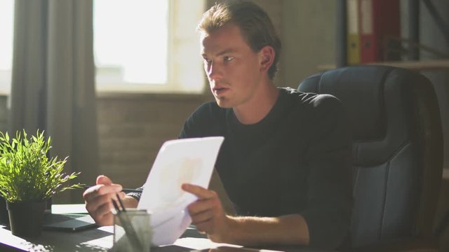 Confident businessman sitting in the modern office explain work to the members. Financial business chart with diagrams
