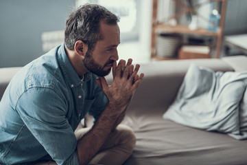 Man having his fingers locked while thinking