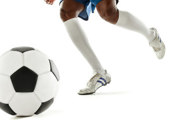 The legs of soccer player close-up isolated on white. African american model in action or movement with ball. The football, game, sport, player, athlete, competition concept