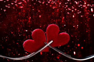 Valentine's Day, hearts and forks against bokeh background