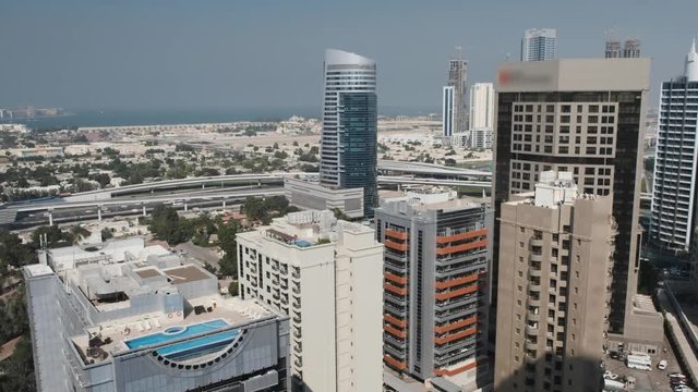 Dubai, January 2019. View from the top of the business district of the city of Dubai - Tecom. In the background are the subway line and the sea.