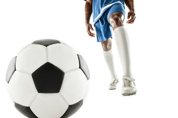 Fototapeta premium The legs of soccer player close-up isolated on white. African american model in action or movement with ball. The football, game, sport, player, athlete, competition concept