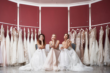 Three thoughtful brides sitting in wedding dress