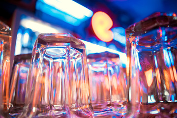 glasses of beer hanging in a bar