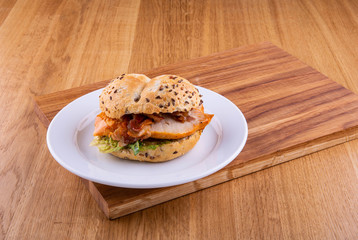 Sandwich chicken on a plate on a wooden board 