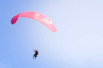 Paraglider floating in the air against the sky. Close-up / Parachute close-up