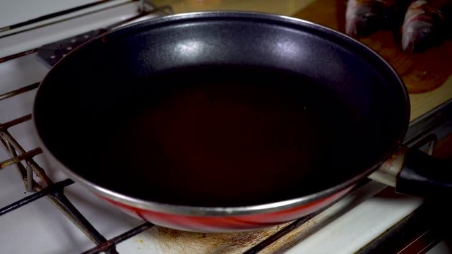 A chef cooks a Sea bass in frying pan.cooking concept. 4k, seafood