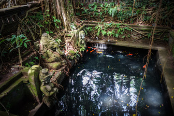 Ganesh statue near a pond in the Monkey Forest, Ubud, Bali, Indonesia