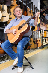 Man playing on acoustic guitar