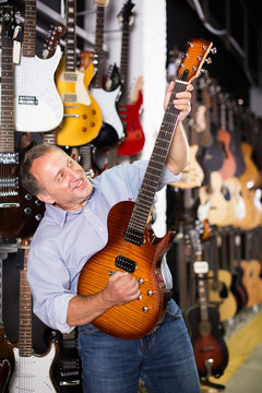 Man choosing electric guitar