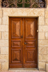 Fototapeta na wymiar Wooden brown doors in a stone building