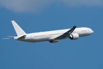 Fototapeta na wymiar Large passenger white twin-engine widebody aircraft in the sky