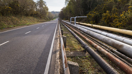 Pipes on roadside, Fawley, Hampshire, UK