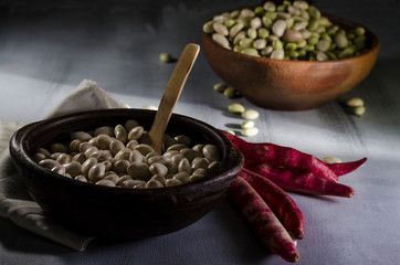 beans in clay basil on a table with ingredients for preparation