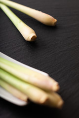 Healthy herb spot focus Lemongrass on black slate stone background with copy space