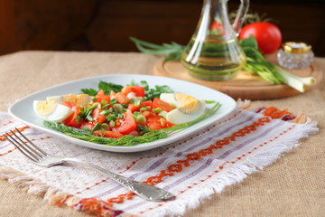 Fresh tomato salad with greens and boiled egg.