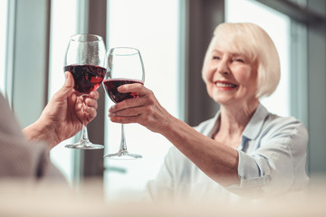 Pretty lady drinking red wine in a restaurant