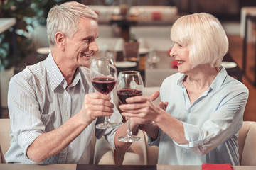 Old couple celebrating an anniversary together in a cafe
