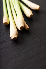 Healthy herb spot focus Lemongrass on black slate stone background with copy space