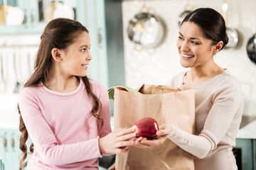 Beautiful female person holding paper bag with products