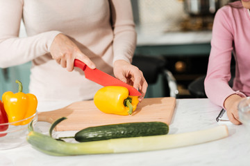 Conscious woman using knife in cooking salad