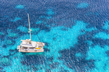Beautiful bay with sailing boat yacht catamaran. Yachting, travel and active lifestyle concept