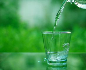 Drinking water in a glass on a wooden table
