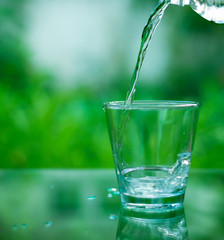 Drinking water in a glass on a wooden table
