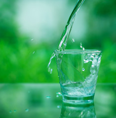 Drinking water in a glass on a wooden table