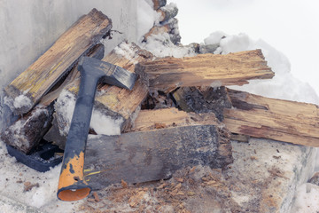 Ax with orange handle and firewood