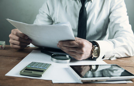 Businessman reading over the terms of the contract. Business concept