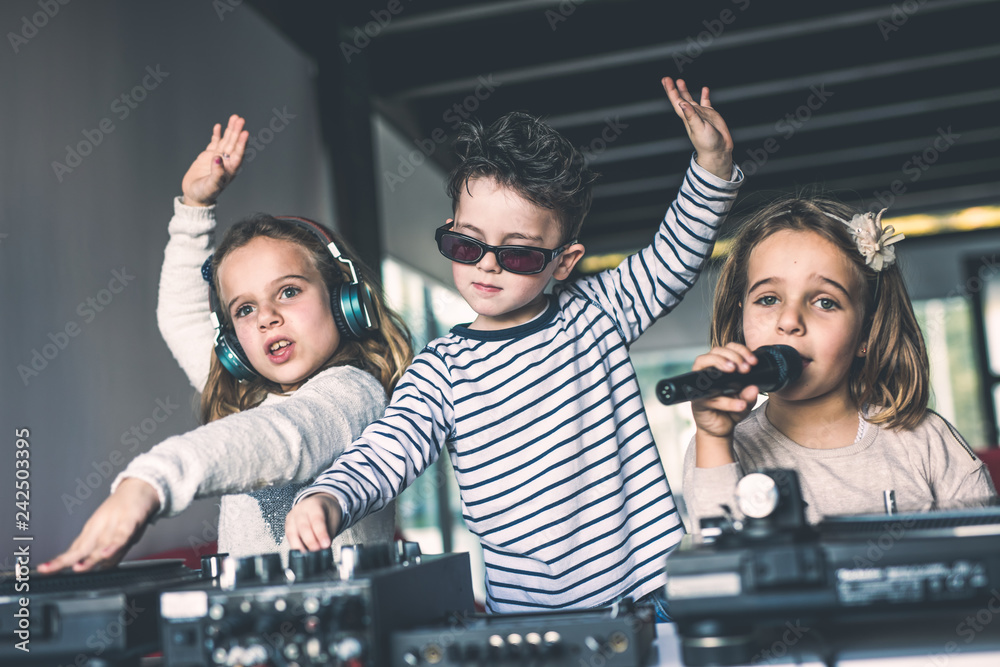 Wall mural young djs make a party at home with vinyl records