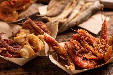 Fish fried fish on a tbale in the street food stand Market