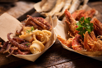 Fish fried fish on a tbale in the street food stand Market