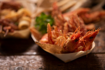 Fish fried fish on a tbale in the street food stand Market