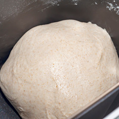 Freshly mixed yeast dough in an automatic bread maker. The dough into the rye flour. Bread maker kneads rye dough.