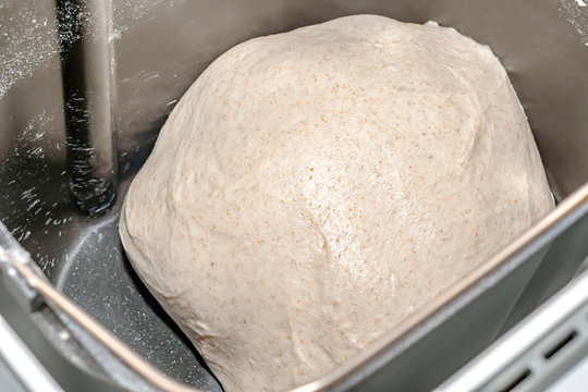 Freshly mixed yeast dough in an automatic bread maker. The dough into the rye flour. Bread maker kneads rye dough.