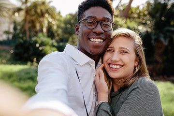 Beautiful interracial couple making a selfie
