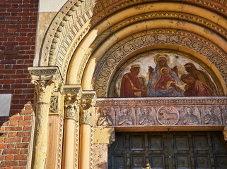 Fresco of the Three Kings on the main facade of the Basilica of Saint Eustorgio. View from Piazza Sant'Eustorgio square. Milan, Lombardy, Italy.