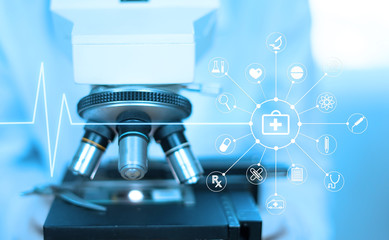 doctor supervisor looking at the microscope slide in the forensic,Laboratory Medical scientists working at lab with test tubes researcher performs liquid,Laboratory concept with medical icon